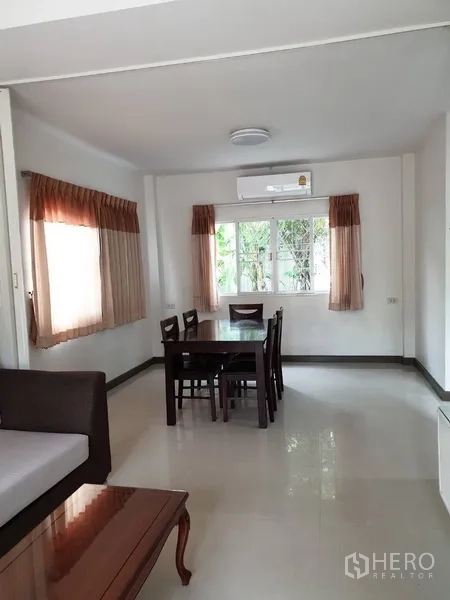 Detached House for rent in Khlong Toei, Bangkok - Dining area with table for four, corner windows and glossy tiled flooring.