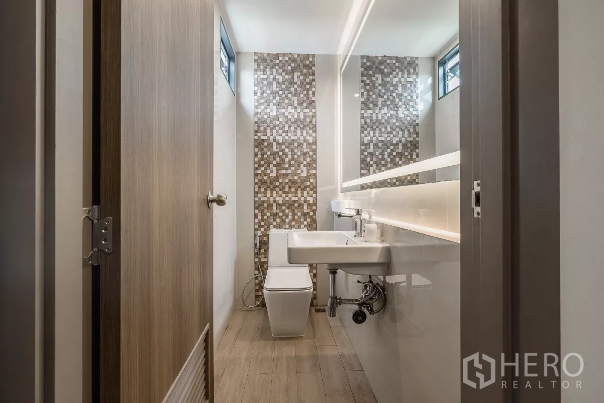 Home Office for sale in Don Mueang, Bangkok - Narrow restroom with mosaic feature wall, long illuminated mirror and light wood floor.