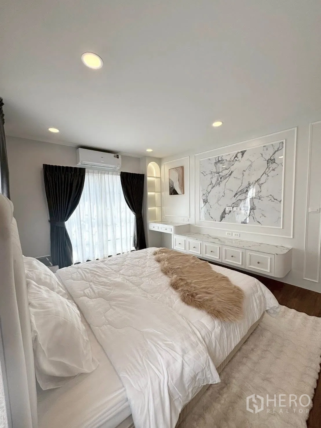 Detached House for rent in Bang Phli, Samut Prakan - Bedroom angle showing built-in vanity, marble wall panel and soft lighting.