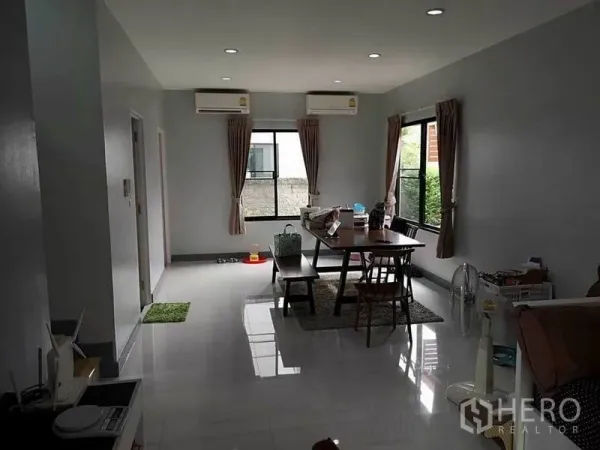 Detached House for sale in Bang Phli, Samut Prakan - Bright open-plan living and dining room with glossy floors, windows and two air conditioners