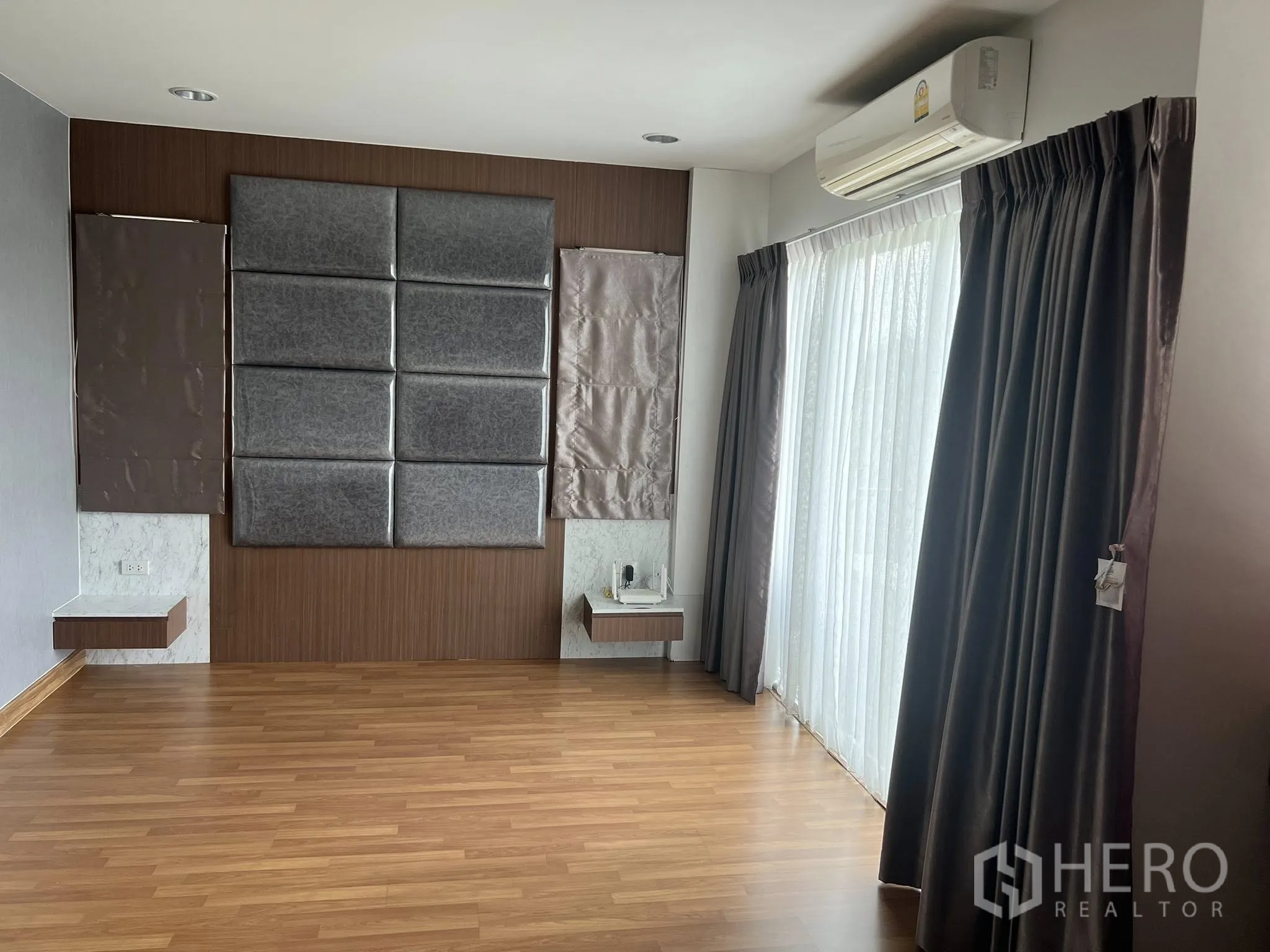 Detached House for rent or sale in Don Mueang, Bangkok - Large bedroom or studio with padded wall and full-height curtains.