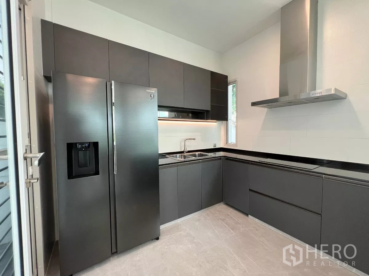 Detached House for sale in Bang Phli, Samut Prakan - Secondary kitchen with grey cabinetry, range hood and double-door fridge