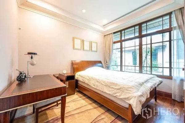 Detached House for sale - Bright guest bedroom with wooden bed, study desk and garden-facing window.