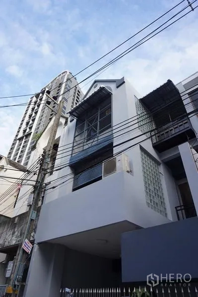 สำนักงานที่บ้าน ให้เช่าในKhlong Toei, Bangkok - ด้านหน้าตึกสูงหลายชั้นพร้อมระเบียงและบล็อกแก้วมองจากริมถนน