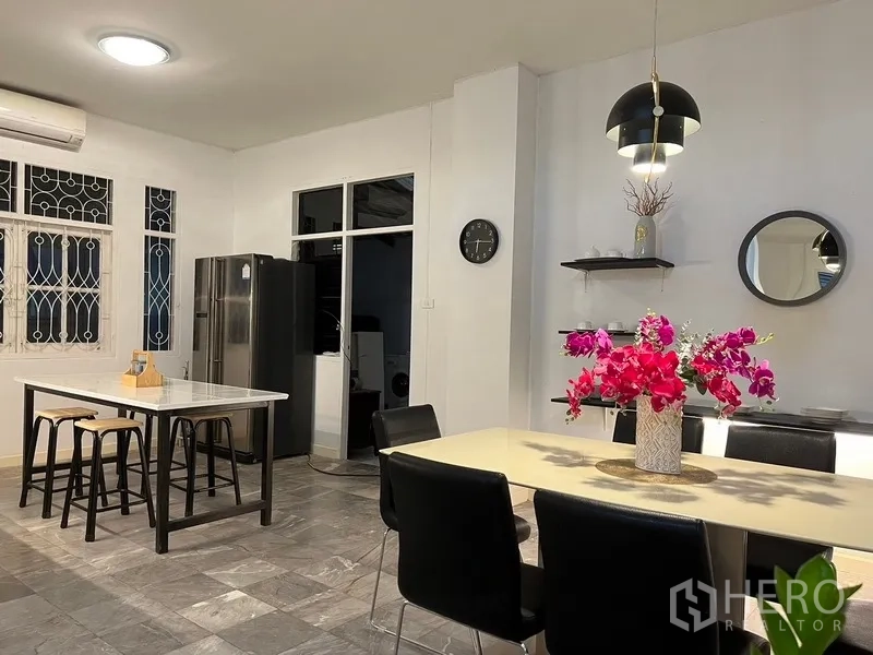 Home Office for rent in Suan Luang, Bangkok - Dining space and breakfast island next to tall fridge and windows.