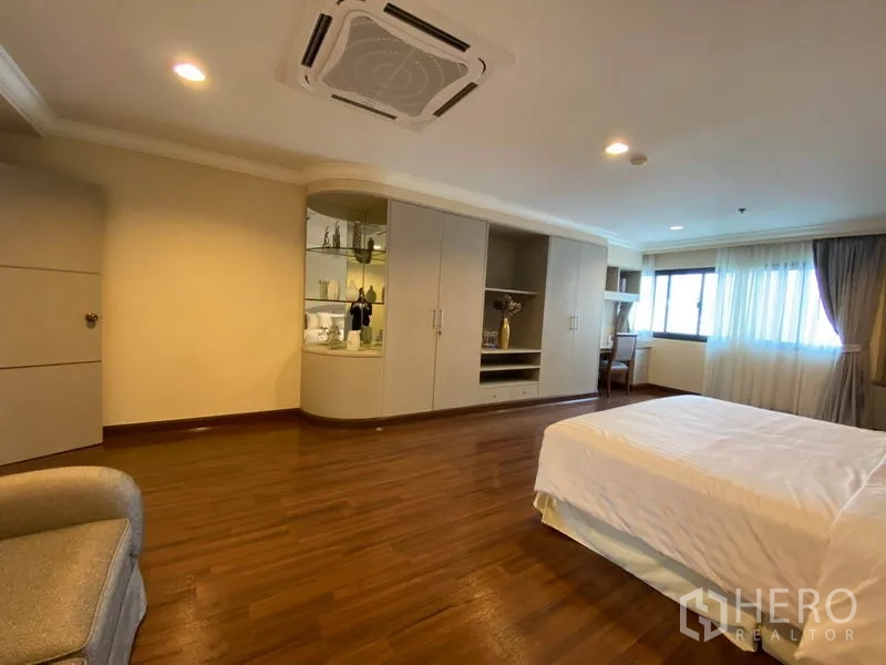 Condominium for rent in Watthana, Bangkok - Master bedroom view showing built-in wardrobes, display cabinet and work desk by the windows.
