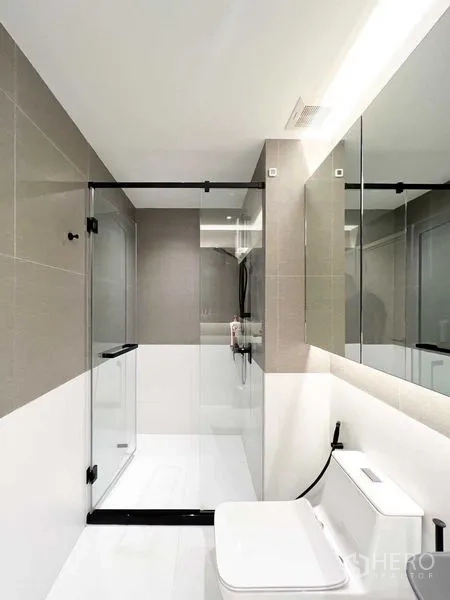 Condominium for rent or sale - Minimalist bathroom with glass shower enclosure and neutral tiles.