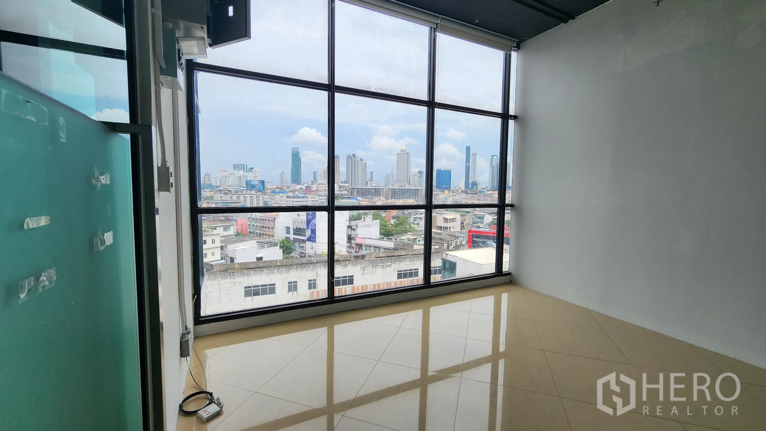 Office Space for rent in Yan Nawa, Bangkok - Small meeting room with full-height window overlooking Bangkok skyline.