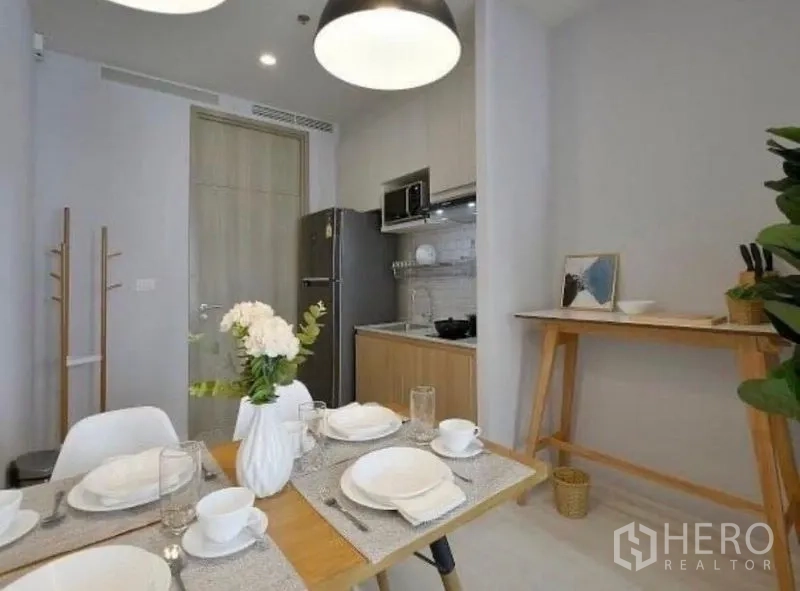 คอนโด ให้เช่าในPathum Wan, Bangkok - มุมรับประทานอาหารข้างครัวขนาดกะทัดรัด ตู้เย็นใหญ่ และแสงไฟสมัยใหม่