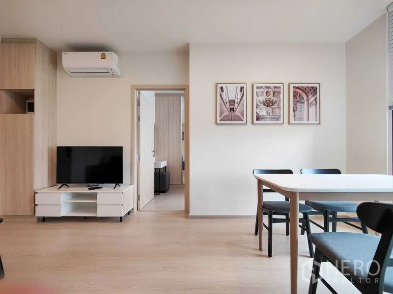 Condominium for rent - Living wall with flat-screen TV, air conditioner and dining set beneath framed artwork.