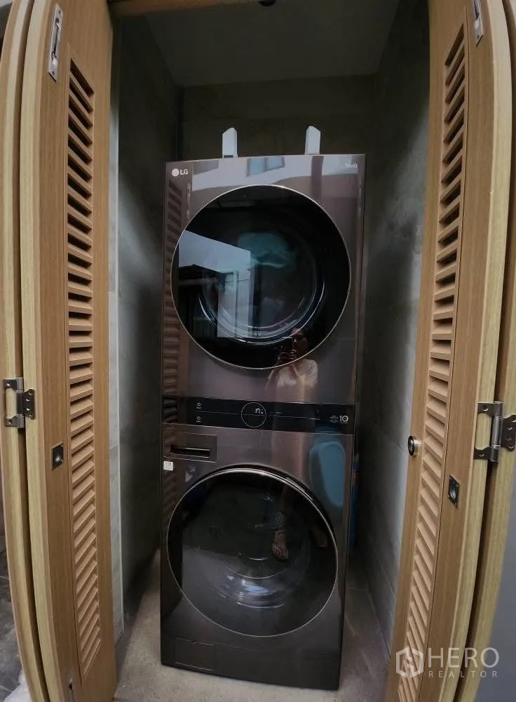 Detached House for rent in Bang Phli, Samut Prakan - Stacked washer and dryer neatly enclosed in a louvered cabinet.