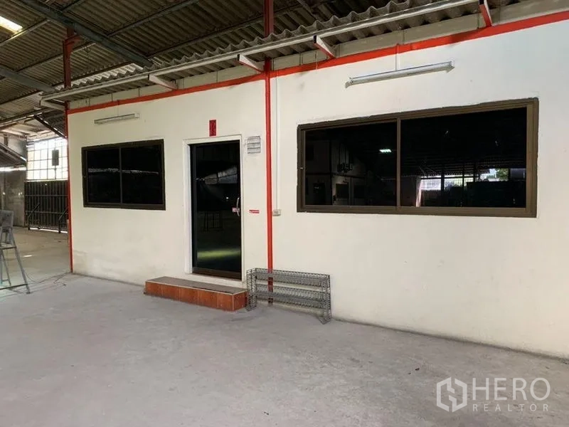Warehouse for rent - Close-up of warehouse office facade with dark-tinted windows.