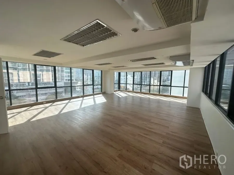 Office Space for rent in Sathon, Bangkok - Bright corner office with cassette air-conditioning, grid ceiling lights, and panoramic city views.