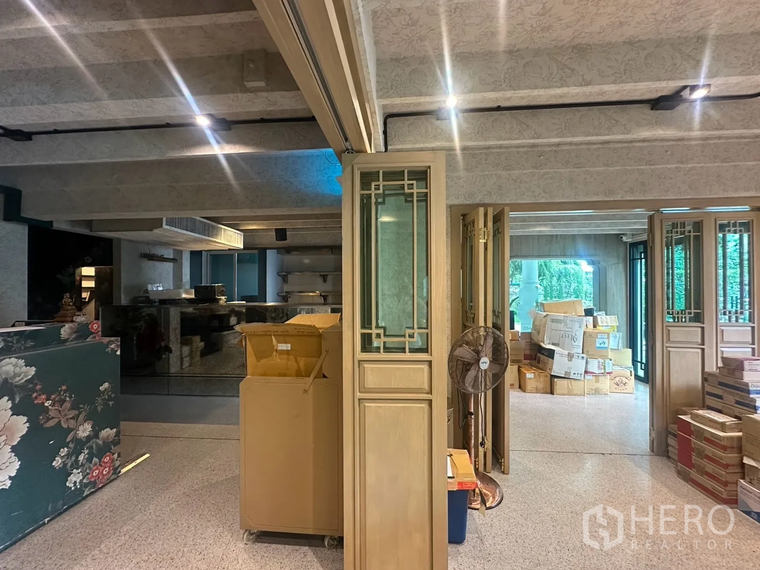 Detached House for rent in Watthana, Bangkok - Ground floor space with mirrored bar, exposed beams, and storage boxes.