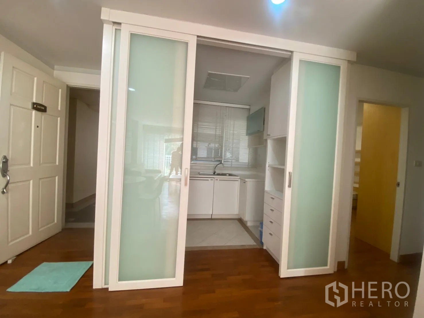 Condominium for rent or sale in Sathon, Bangkok - Entry to the unit facing sliding glass doors to the enclosed kitchen.