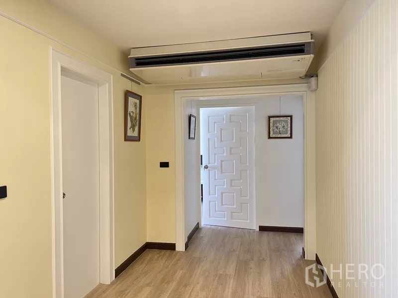คอนโด ให้เช่าในKhlong Toei, Bangkok - โถงทางเดินพร้อมเครื่องปรับอากาศติดฝ้าและประตูภายในลายเรขาคณิตสีขาว