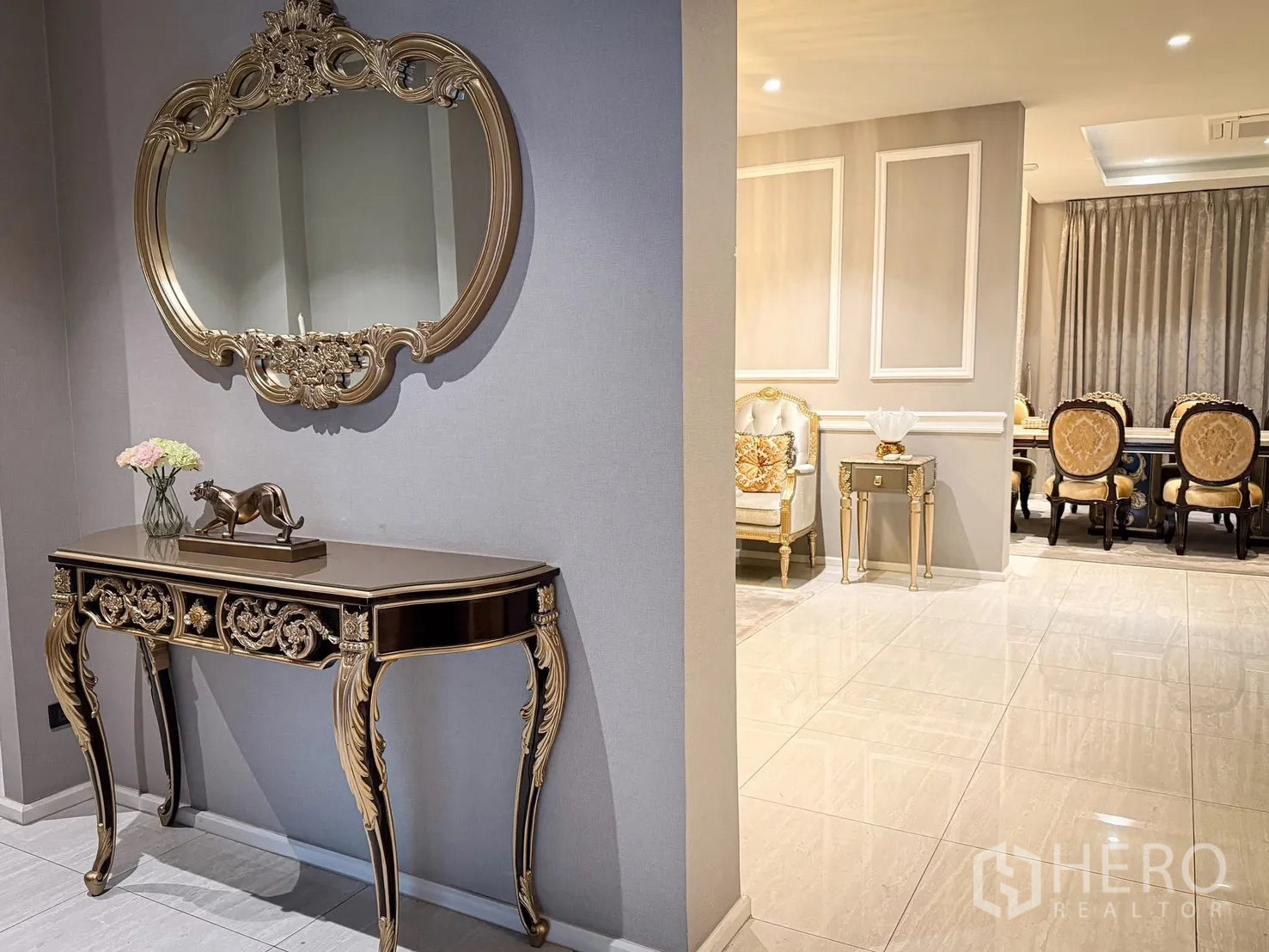 Detached House for rent or sale in Lak Si, Bangkok - Hallway with decorative console and mirror leading to a formal dining room.