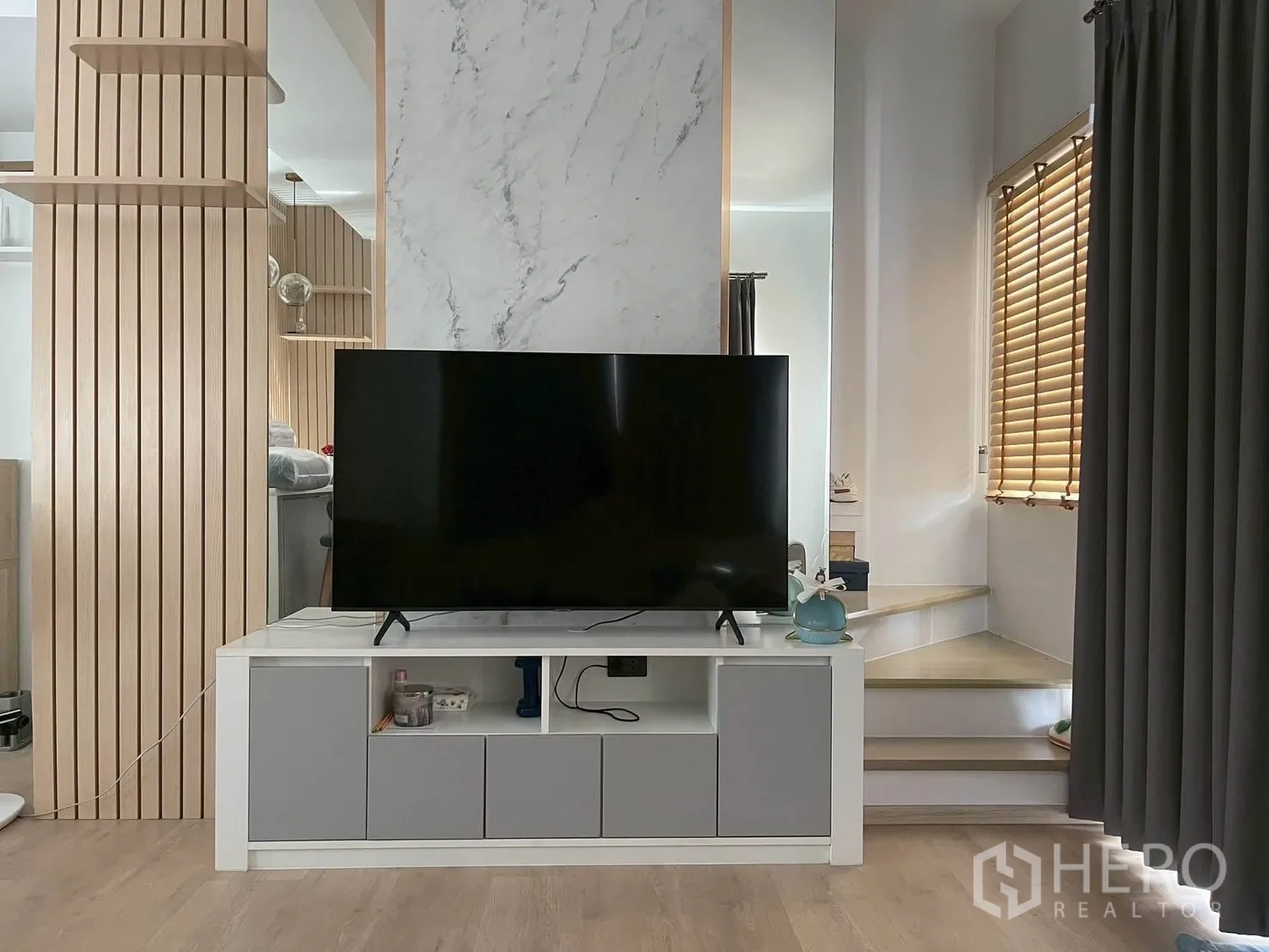 Townhouse for rent in Bang Phli, Samut Prakan - Living area with TV console, marble accent and stairs.