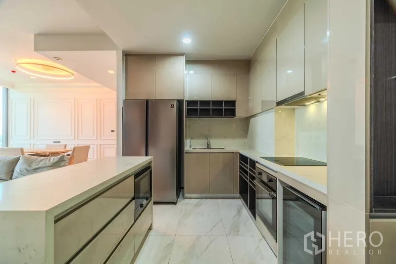 Condominium for rent or sale - Full kitchen with island, double sinks, large fridge, and glossy cabinetry.