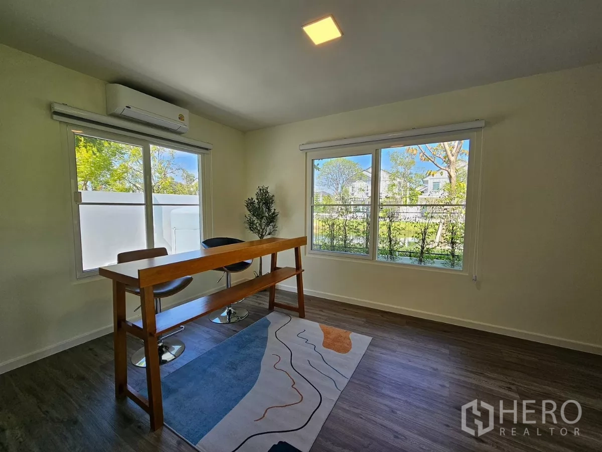 Detached House for rent in Bang Phli, Samut Prakan - Sunlit multipurpose room with long bar-height table and large windows overlooking greenery.