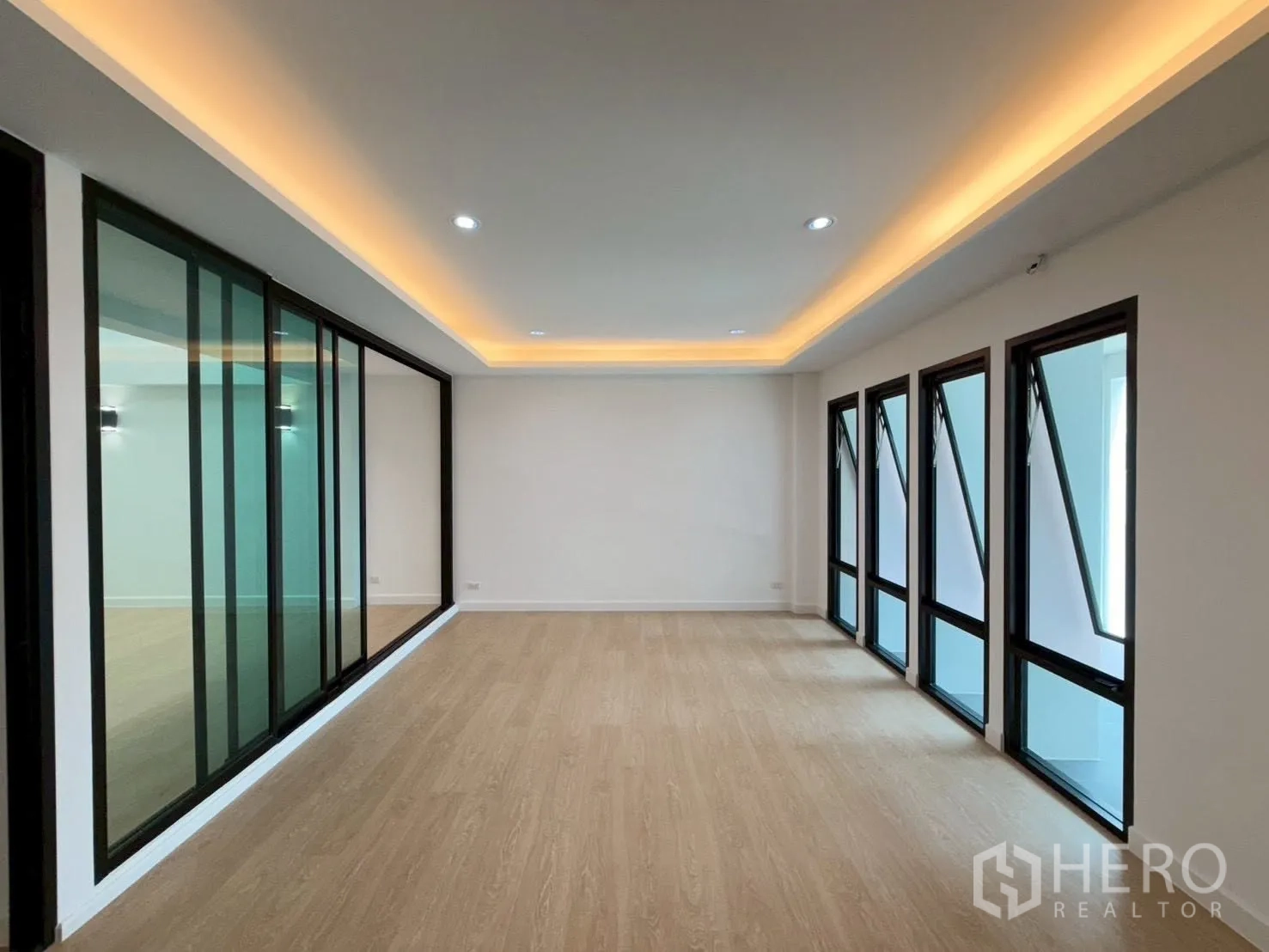 联排别墅 for sale in Phra Khanong, Bangkok - 修长房间，灯槽、数个外推窗与玻璃隔断。