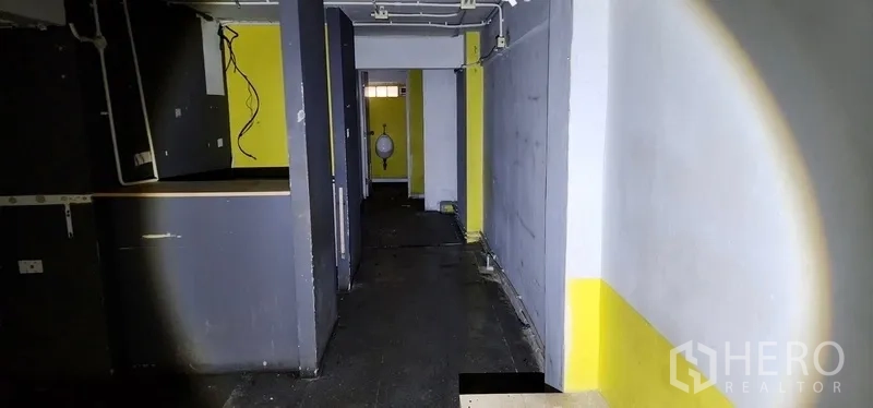 สำนักงานที่บ้าน ให้เช่าในSathon, Bangkok - โถงทางเดินมีฉากกั้นไปยังห้องน้ำ เดินท่อและสายไฟโชว์ ผนังสีเทา-เหลือง