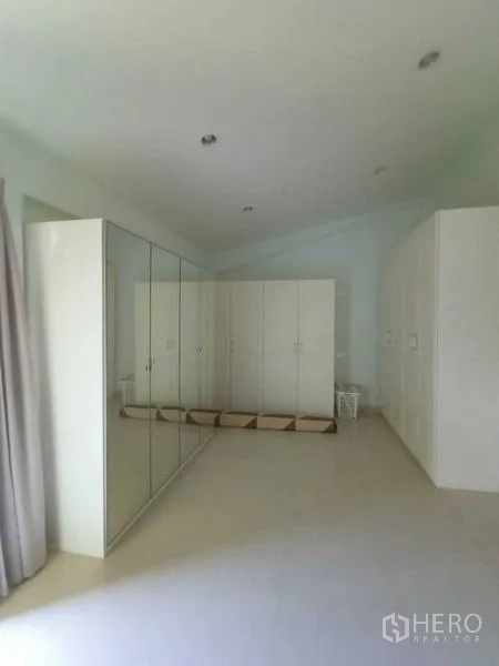 Home Office for rent in Watthana, Bangkok - Large bedroom or studio with multiple white wardrobes and mirrors.