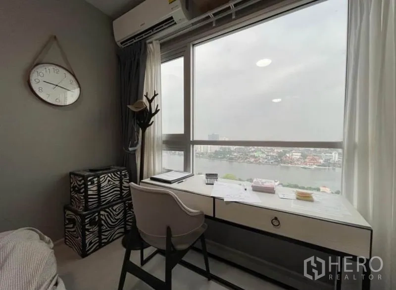 Condominium for sale in Bang Sue, Bangkok - Work desk by a picture window offering panoramic river and city views.