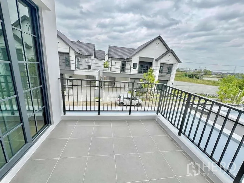 Detached House for sale in Bang Phli, Samut Prakan - Private balcony with tiled floor and black railing overlooking the neighborhood.