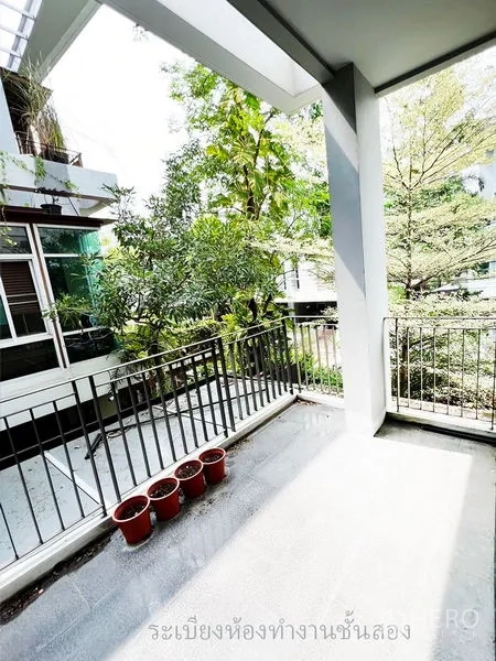 Townhouse for rent or sale in Don Mueang, Bangkok - Second-floor balcony overlooking greenery and neighboring homes.