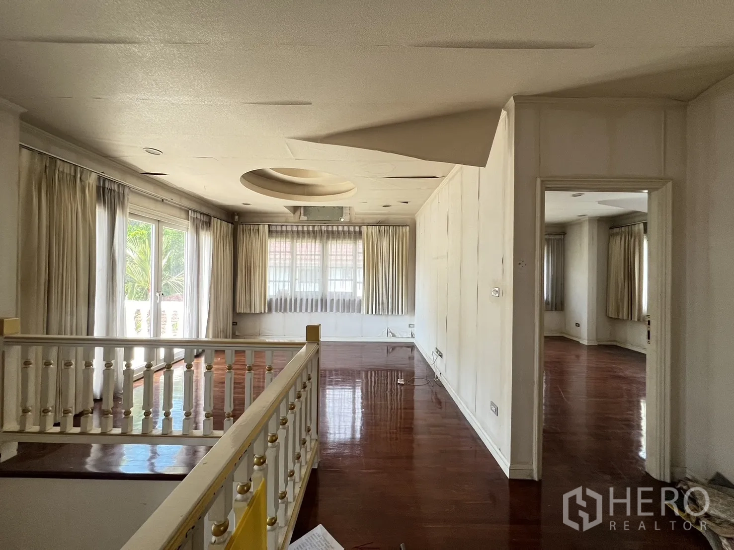 Detached House for sale in Saphan Sung, Bangkok - Upper landing with white balustrade, wood floors, and access to rooms.