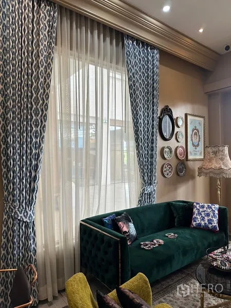 พื้นที่ขายปลีก ให้เช่าในKhlong Toei, Bangkok - มุมนั่งเล่นอบอุ่น ผ้าม่านลายสูง โซฟากำมะหยี่สีเขียว และจานตกแต่งผนังข้างหน้าต่างบานใหญ่