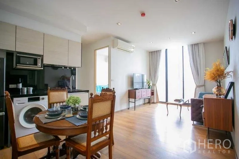 คอนโด ขายในKhlong Toei, Bangkok - ห้องนั่งเล่นและรับประทานอาหารแบบเปิดโล่ง มีหน้าต่างสูงพื้นจรดเพดาน พื้นไม้ และครัวขนาดกะทัดรัด