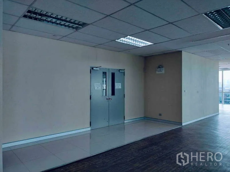 Office Space for rent in Sathon, Bangkok - Internal double doors and tiled landing adjoining an open office area with fluorescent ceiling lights.