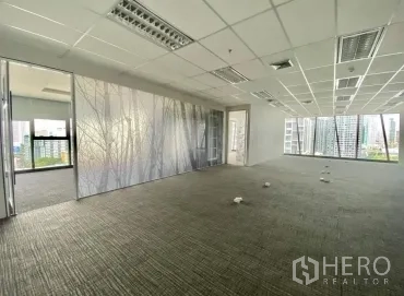 Office Space for rent - Spacious office with frosted glass partition, large windows and views of Bangkok’s business district.
