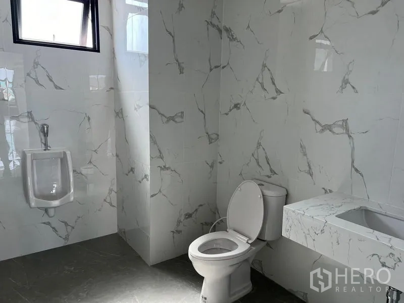 货栈 出租在Bang Sao Thong, Samut Prakan - 整洁的瓷砖卫生间，配坐便器、小便器与洗手台