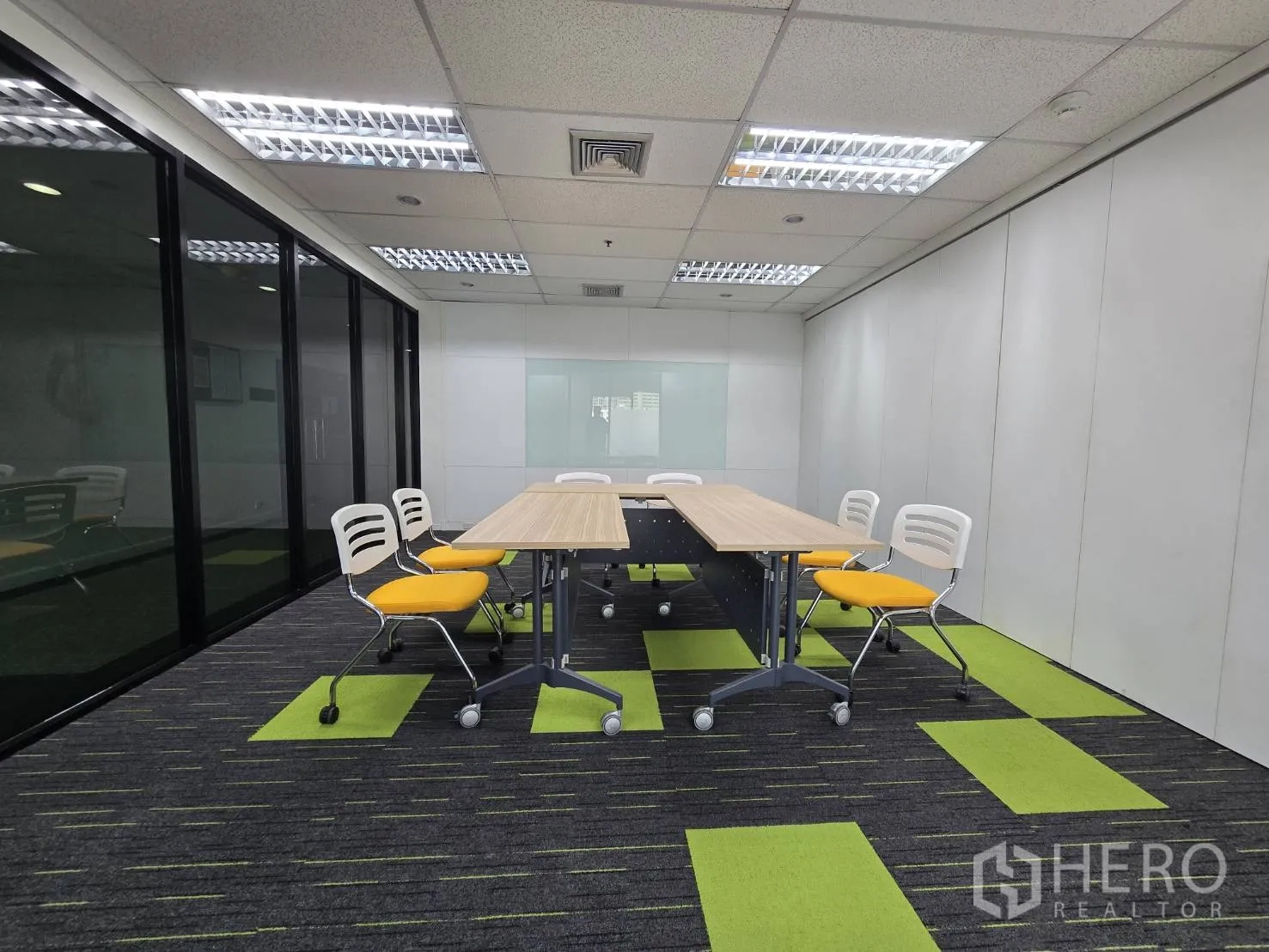 Office Space for rent in Watthana, Bangkok - Meeting room with mobile tables, yellow chairs, and a wall whiteboard.