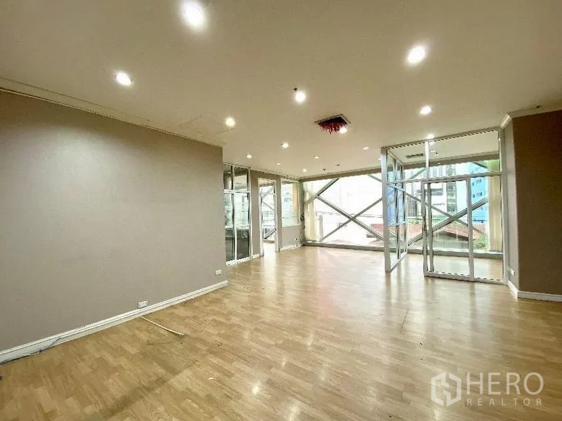 Office Space for rent in Khlong Toei, Bangkok - Corner office space with large windows, wood floors and city outlook with external X-bracing.