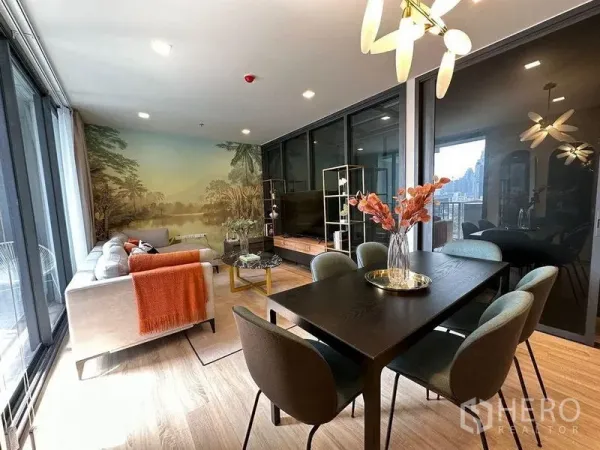 Condominium for rent in Ratchathewi, Bangkok - Wide view of open-plan dining and living area with mural backdrop and large windows.