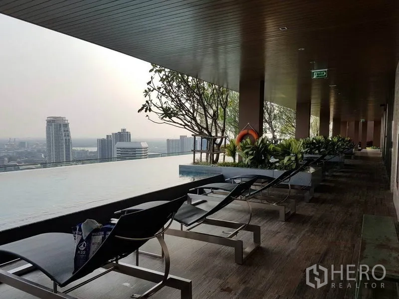 คอนโด ให้เช่าในWatthana, Bangkok - เตียงอาบแดดใต้ชายคาข้างสระอินฟินิตี้