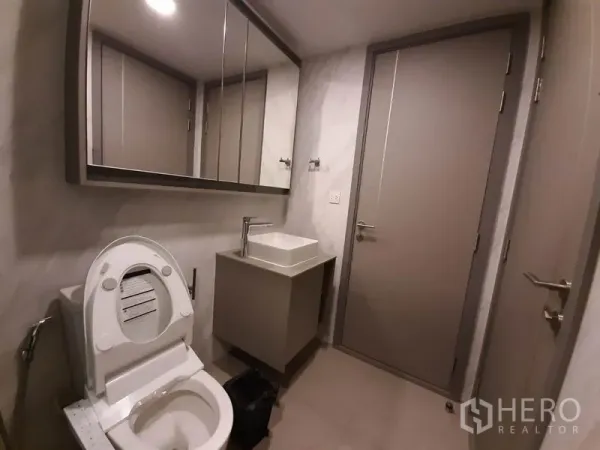 คอนโด ให้เช่าหรือขายในWatthana, Bangkok - ห้องน้ำกะทัดรัดพร้อมตู้กระจกเหนืออ่าง อ่างล้างหน้าทรงเหลี่ยม และโถสุขภัณฑ์