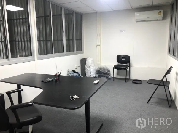 Warehouse for rent in Wang Thonglang, Bangkok - Air-conditioned office room with desks and chairs inside the warehouse.