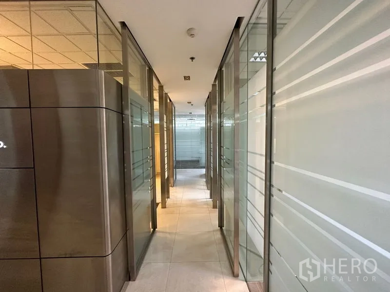 Office Space for rent - Glass-lined corridor with frosted panels connecting multiple office suites.