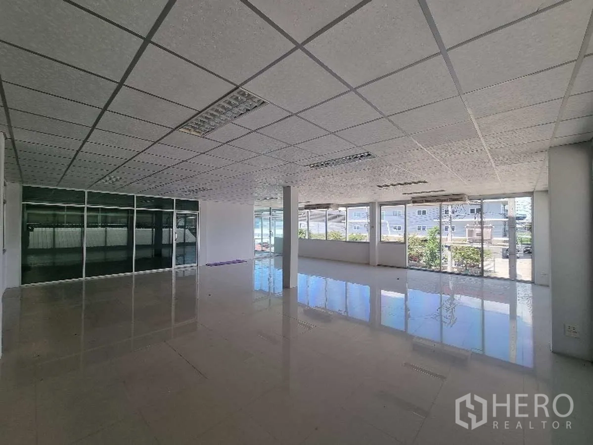 Factory for rent in Samut Prakan - Office space with full-height windows providing ample natural light.