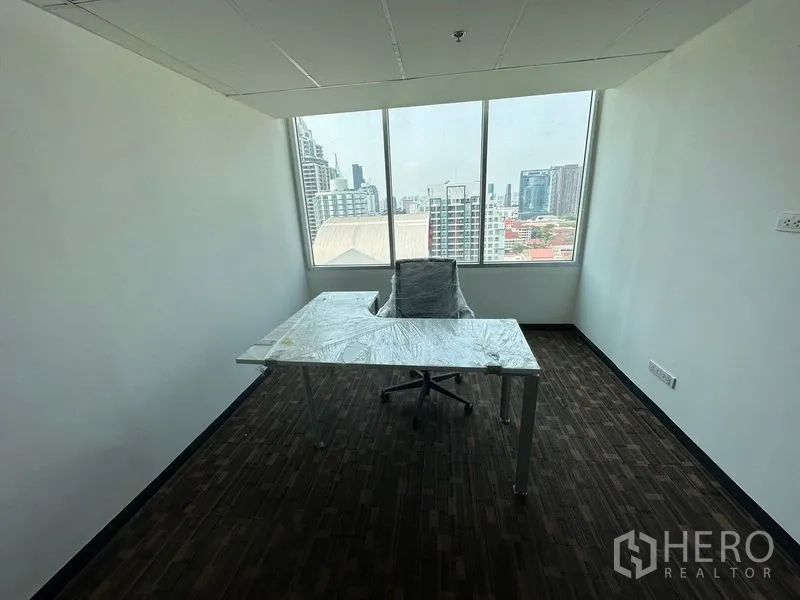 Office Space for rent in Watthana, Bangkok - Single workstation facing big windows with natural light and city views.