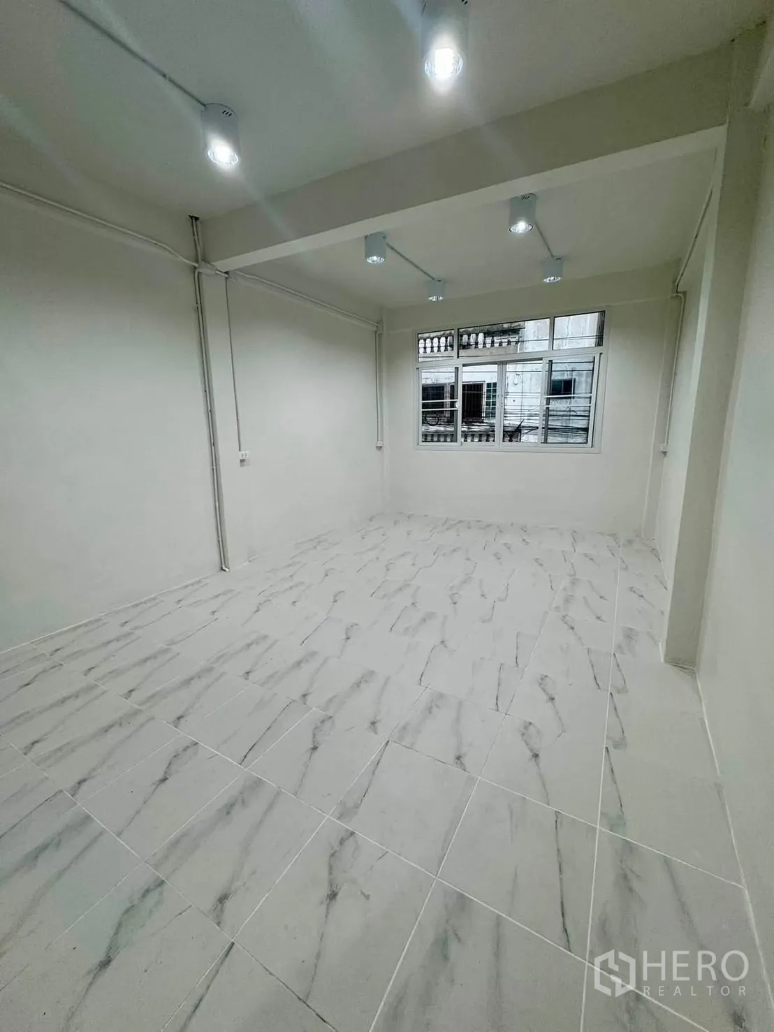 Shophouse for rent in Sathon, Bangkok - Ground-floor shopfront interior with roller shutter entrance.