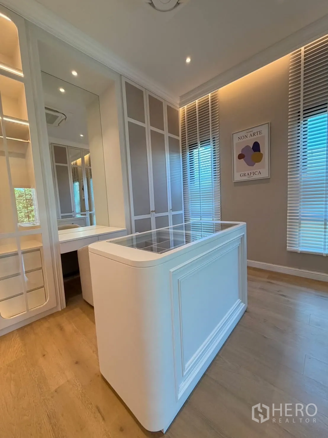 Detached House for rent in Saphan Sung, Bangkok - Another view of the dressing room with storage island, mirrors, and tall cabinets.