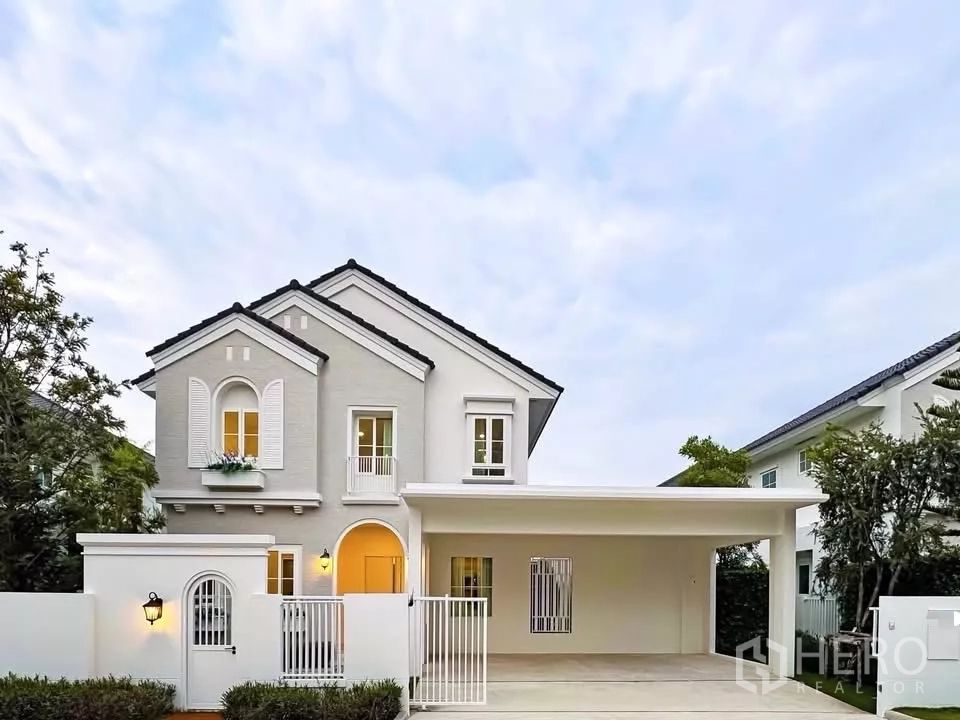 Detached House for rent in Bang Phli, Samut Prakan - Two-storey detached house facade with gabled roof, gated driveway and covered carport.