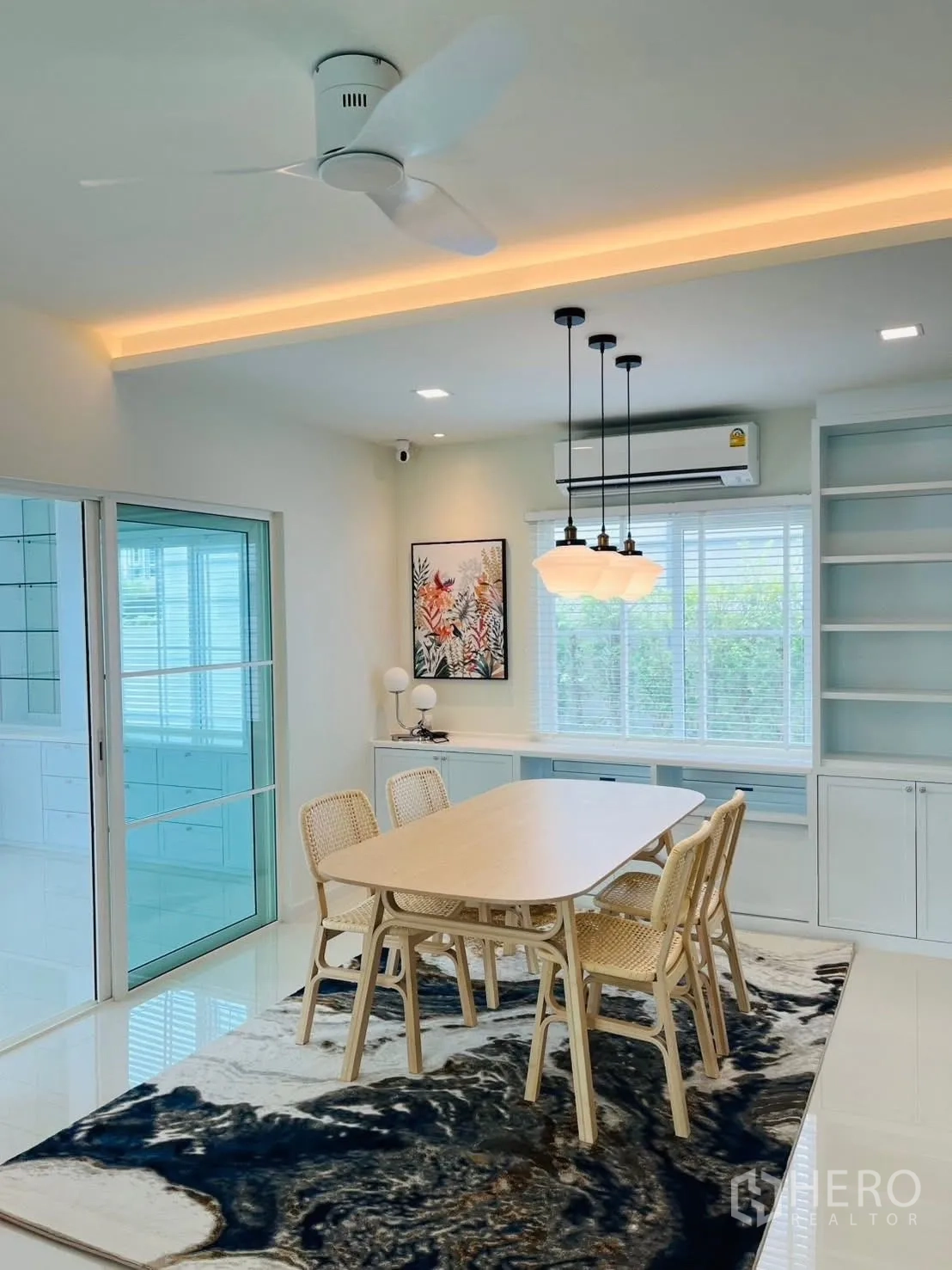Detached House for rent in Bang Phli, Samut Prakan - Dining area with ceiling fan, three pendant lights, and garden outlook.