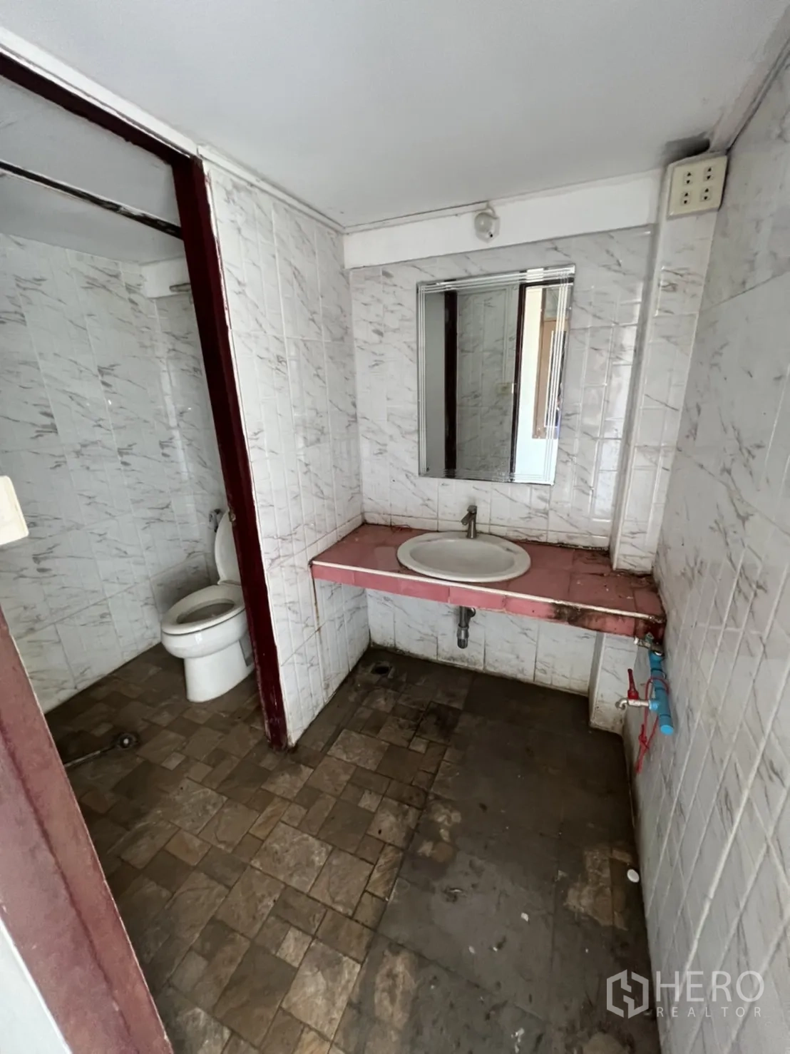 Home Office for rent in Watthana, Bangkok - Shared bathroom showing sink and separate toilet section.